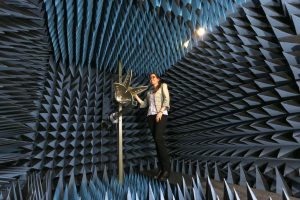 person in electromagnetic RF anechoic chamber with quad ridged horn antenna
